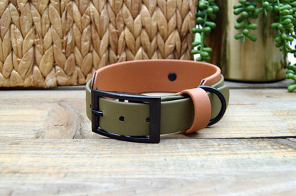 An Olive Green and Caramel biothane dog collar on a wooden surface with a woven basket and plant in the background.