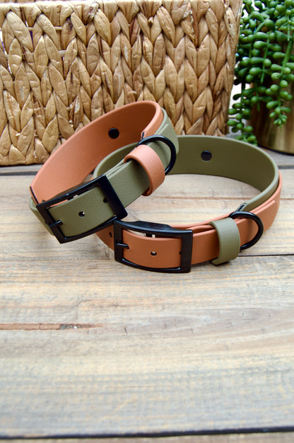 Two dog collars, one brown and one green, on a wooden surface with a woven basket in the background.