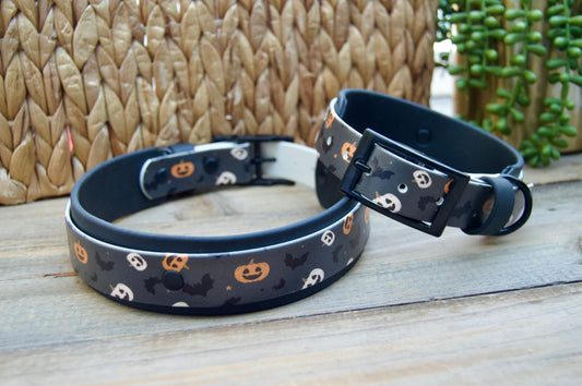 Two Halloween-themed dog collars on a wooden surface with a woven basket background.